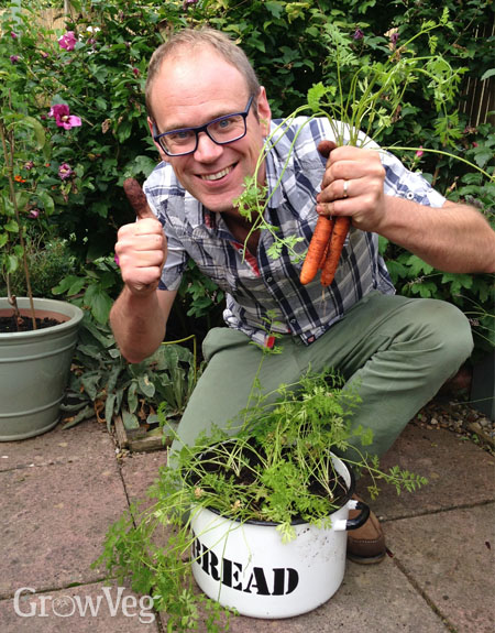 Ben with container-grown carrots