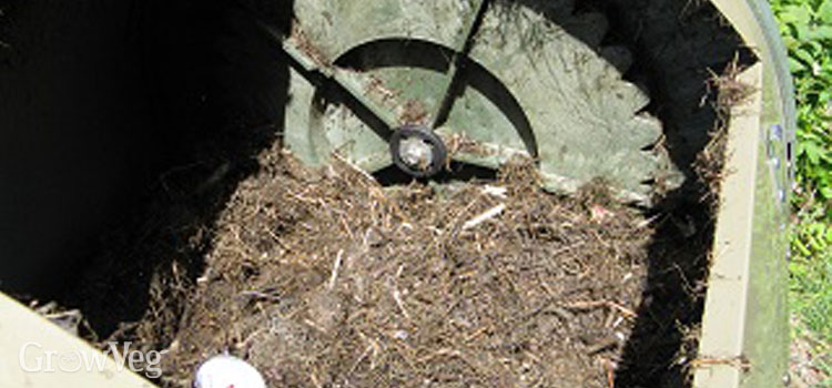 Compost tumbler contents reduced by half