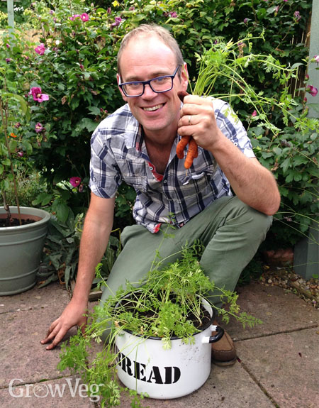 Ben with container-grown carrots