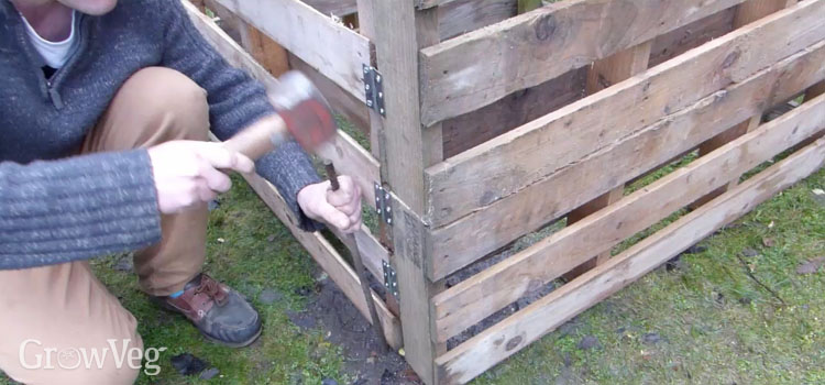 Securing pallet composter in place with length of rebar